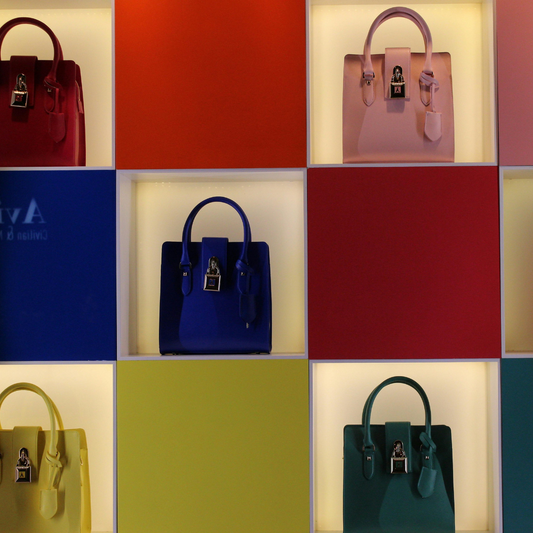 different colour handbags in different coloured square boxes
